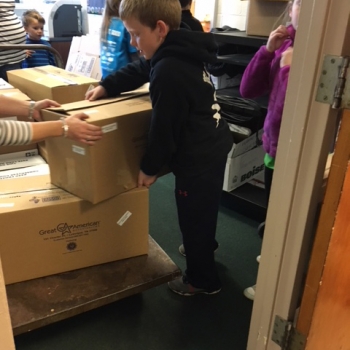 Students loading food drive items